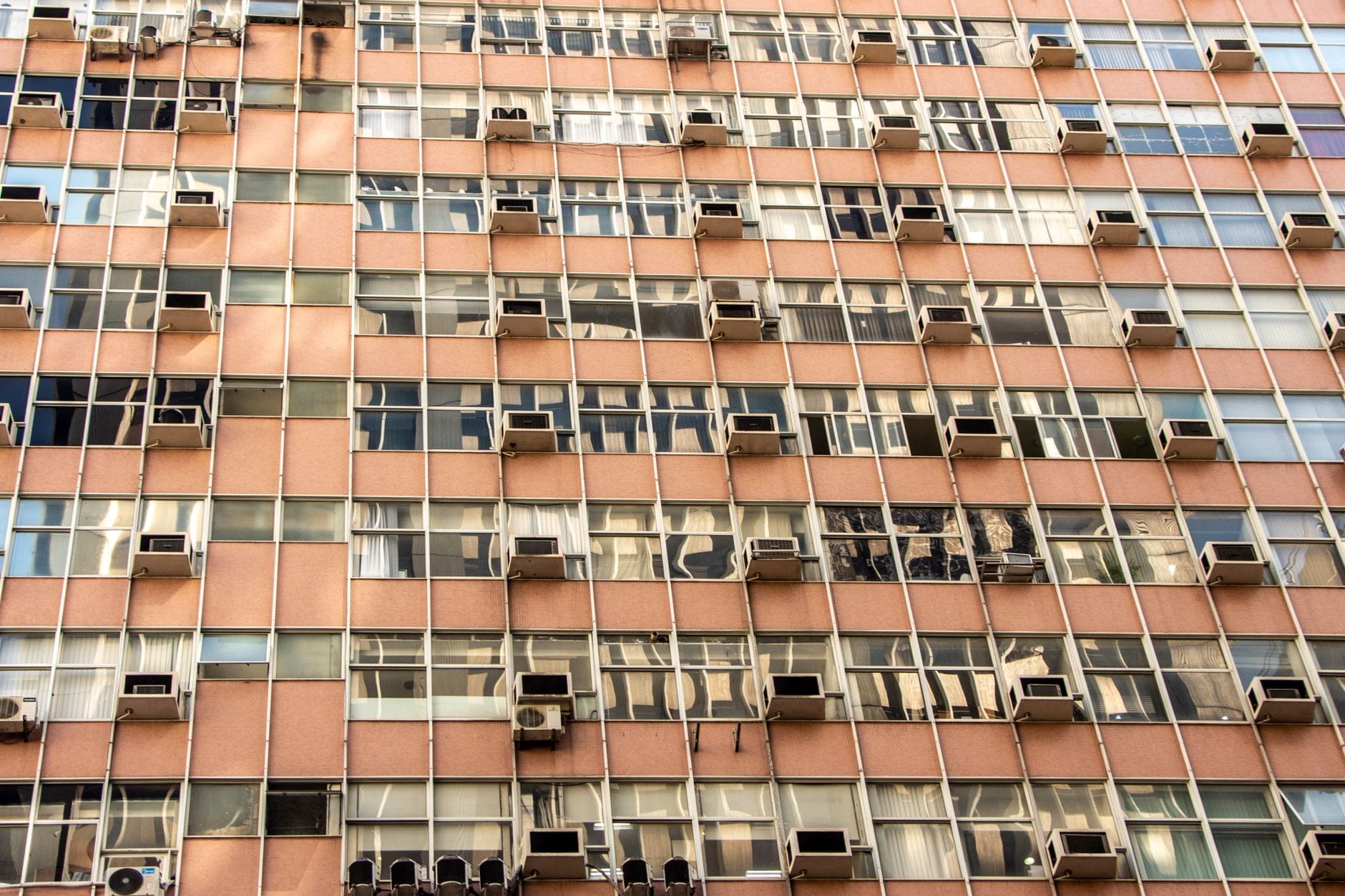 Fasada miejskiej kamienicy z oknami i zamontowanymi klimatyzatorami
